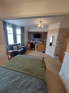 a bedroom with a bed and a living room at Westfield House in Blackpool