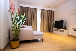 a living room with a couch and a tv at The Pavilion 1BDR Luxury Apt in Accra