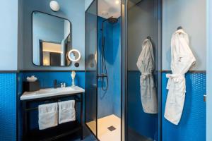 a bathroom with a shower and a sink and a mirror at The Editory Riverside Hotel, an Historic Hotel in Lisbon