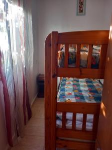 a bunk bed with a quilt on the bottom bunk at Casa rural entre la naturaleza Gomera in El Cercado