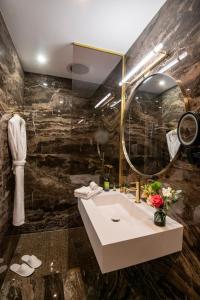 La salle de bains est pourvue d'un lavabo et d'un miroir. dans l'établissement Hôtel Petit Palais, à Nice