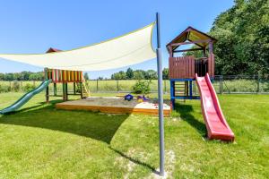 a playground with two slides and a hoop at KempingZator Glamping in Zator