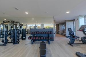 a gym with a lot of treadmills and weights at Al-411 Estepona - Apartment - Alcazaba Lagoon in Estepona