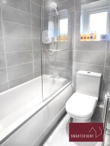 a bathroom with a white toilet and a shower at Farnborough - Newly Refurbished 2 Bedroom Home in Blackwater
