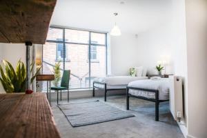 a bedroom with two beds and a window at Central Townhouse With Roof Terrace in Manchester