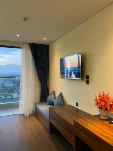 a living room with a flat screen tv on the wall at Ghé Home - Homestay Phú Yên in Phu Yen