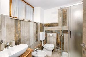 a bathroom with a toilet and a sink and a shower at Il Capriolo Aosta in Aosta