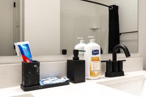 a bathroom sink with a bottle of toothpaste and a mirror at Corporate Housing by MGM in Whitestown +38 photos