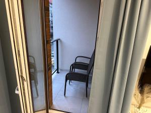 a view of a room with a chair and a mirror at Złote Apartamenty 24 in Legnica