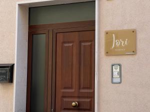 a wooden door with a phone next to it at Residence Lori in Brindisi