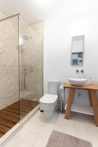 a bathroom with a toilet and a sink and a shower at La Iaz in Murighiol +33 photos