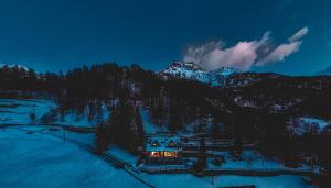 a house in the middle of a snow covered mountain at Chalet Snostorm in Crépin