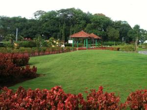 a large field with a gazebo in a park at Royal Park Hotel Dockyard in Mumbai