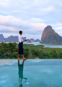 a man standing on top of a pool of water at Sametnangshe Boutique in Phangnga
