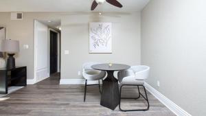 a dining room with a table and white chairs at Landing Modern Apartment with Amazing Amenities (ID8118X32) in Temecula
