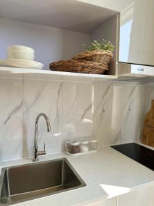 a kitchen with a sink and a counter top at Lazzlla beachside studio apartments in Hulhumale