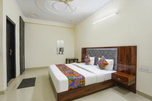 a bedroom with a large bed in a room at FabHotel ASP Royal Residency Inn- Janakpuri in New Delhi