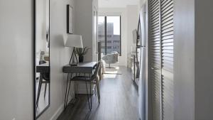 a hallway with a desk and a table in a room at Landing - Modern Apartment with Amazing Amenities (ID1401X749) in Nashville