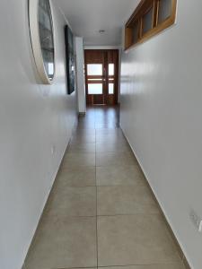 a hallway with white walls and a tile floor at Vista marina Marbella in Juan Pedro