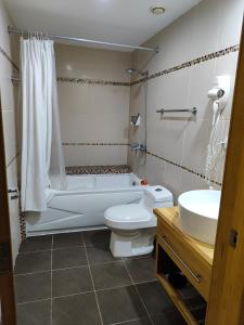 a bathroom with a tub and a toilet and a sink at Vista marina Marbella in Juan Pedro
