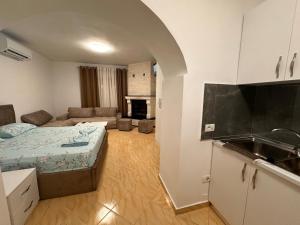 a small apartment with a bed and a kitchen at Bujtina Sakollari in Poliçan