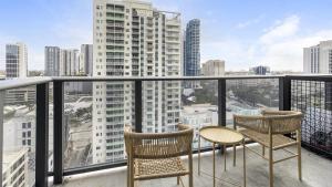 a balcony with two chairs and a table on a balcony at Landing Modern Apartment with Amazing Amenities (ID1283X920) in Fort Lauderdale