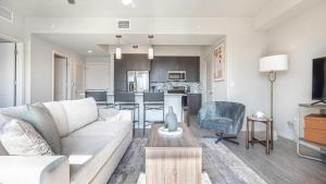 a living room with a couch and a table at Landing Modern Apartment with Amazing Amenities (ID8083X57) in Fort Myers Villas