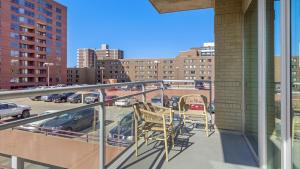 a balcony with two chairs and a view of a parking lot at Landing Modern Apartment with Amazing Amenities (ID6240X71) in Denver