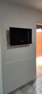 a flat screen tv on a white wall at SAN BERNARDO in San Bernardo