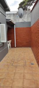 a patio with a brick wall and a white chair at SAN BERNARDO in San Bernardo