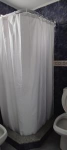 a bathroom with a white shower curtain and a toilet at SAN BERNARDO in San Bernardo +9 photos