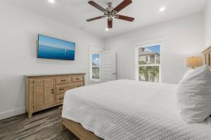 a bedroom with a bed and a ceiling fan at The Sand Emperor With Heated Pool And Game Room in Destin