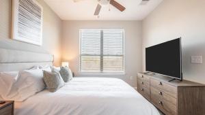 a bedroom with a bed and a flat screen tv at Landing Modern Apartment with Amazing Amenities (ID7989X60) in Greenville