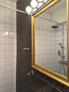 a bathroom with a mirror and a shower at Hotel Victoria in Skellefteå