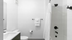 a white bathroom with a toilet and a sink at Landing Modern Apartment with Amazing Amenities (ID1791X13) in Richmond