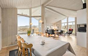 a kitchen and dining room with a table and chairs at Holiday Home Henriettevej Hvide Sande Ix in Bjerregård