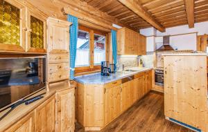 a kitchen with wooden cabinets and a counter top at Ferienhaus In Wagrain in Wagrain