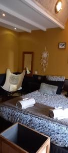 a bedroom with a bed and a desk and a chair at LA MESONNETTA in Soulignonne