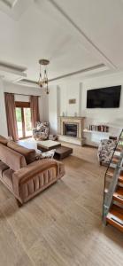 a large living room with couches and a fireplace at Villa Bianca in Muğla