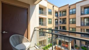 a balcony with a chair and a building at Landing Modern Apartment with Amazing Amenities (ID3704X38) in Frisco