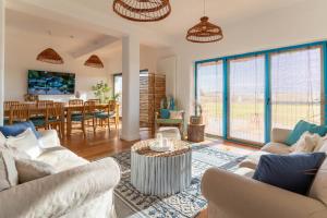 a living room with two couches and a dining room at La Iaz in Murighiol