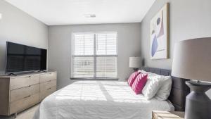 a bedroom with a bed and a flat screen tv at Landing Modern Apartment with Amazing Amenities (ID3676X65) in Perrysburg