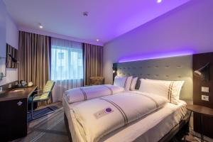 a bedroom with a large bed with a purple ceiling at Premier Inn Hamburg St. Pauli in Hamburg
