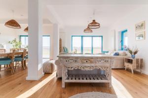 a living room with a table and a dining room at La Iaz in Murighiol