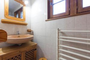 a bathroom with a sink and a mirror at Chalet de 7 chambres avec terrasse et wifi a Saint Gervais les Bains in Saint-Gervais-les-Bains