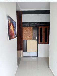 an empty room with a kitchen and a door at OP Krishna Homestay in Mathura
