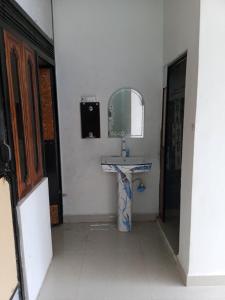 a bathroom with a sink and a mirror at OP Krishna Homestay in Mathura