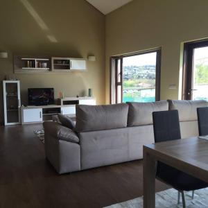 a living room with a couch and a table at 4 bedrooms house with private pool jacuzzi and wifi at Roxos in Santiago de Compostela