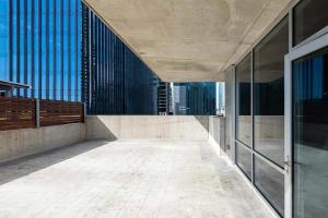 an empty corridor of a building with glass walls at Landing Modern Apartment with Amazing Amenities (ID6221) in Austin