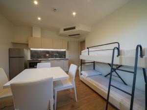 a room with a bunk bed and a table and chairs at Castiglioncello Suite in Castiglioncello